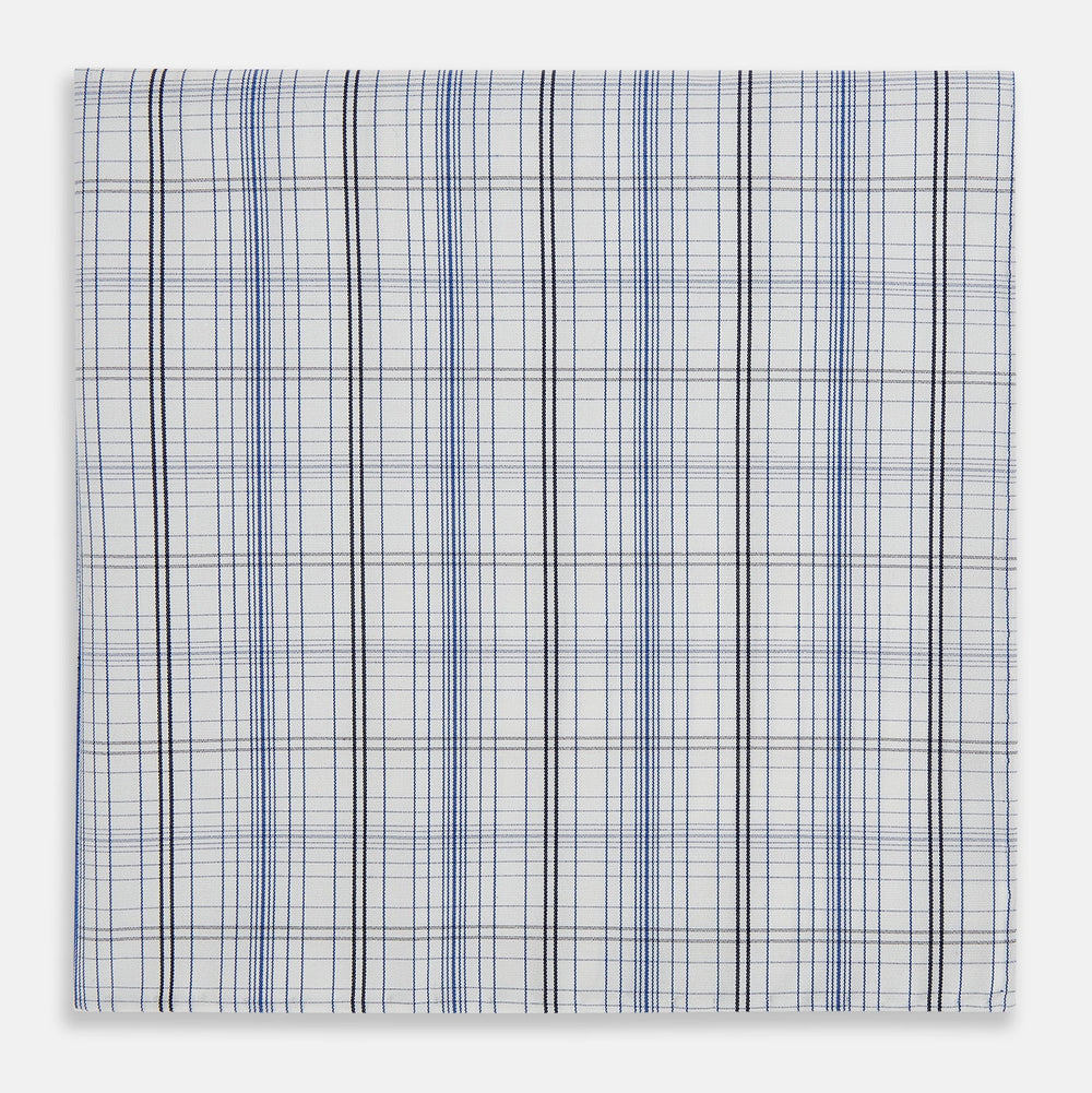 The Turnbull & Asser Blue and Navy Multi Check Hand-Rolled Handkerchief features a blue and white plaid design with thin, evenly spaced lines, shown flat against a white background.