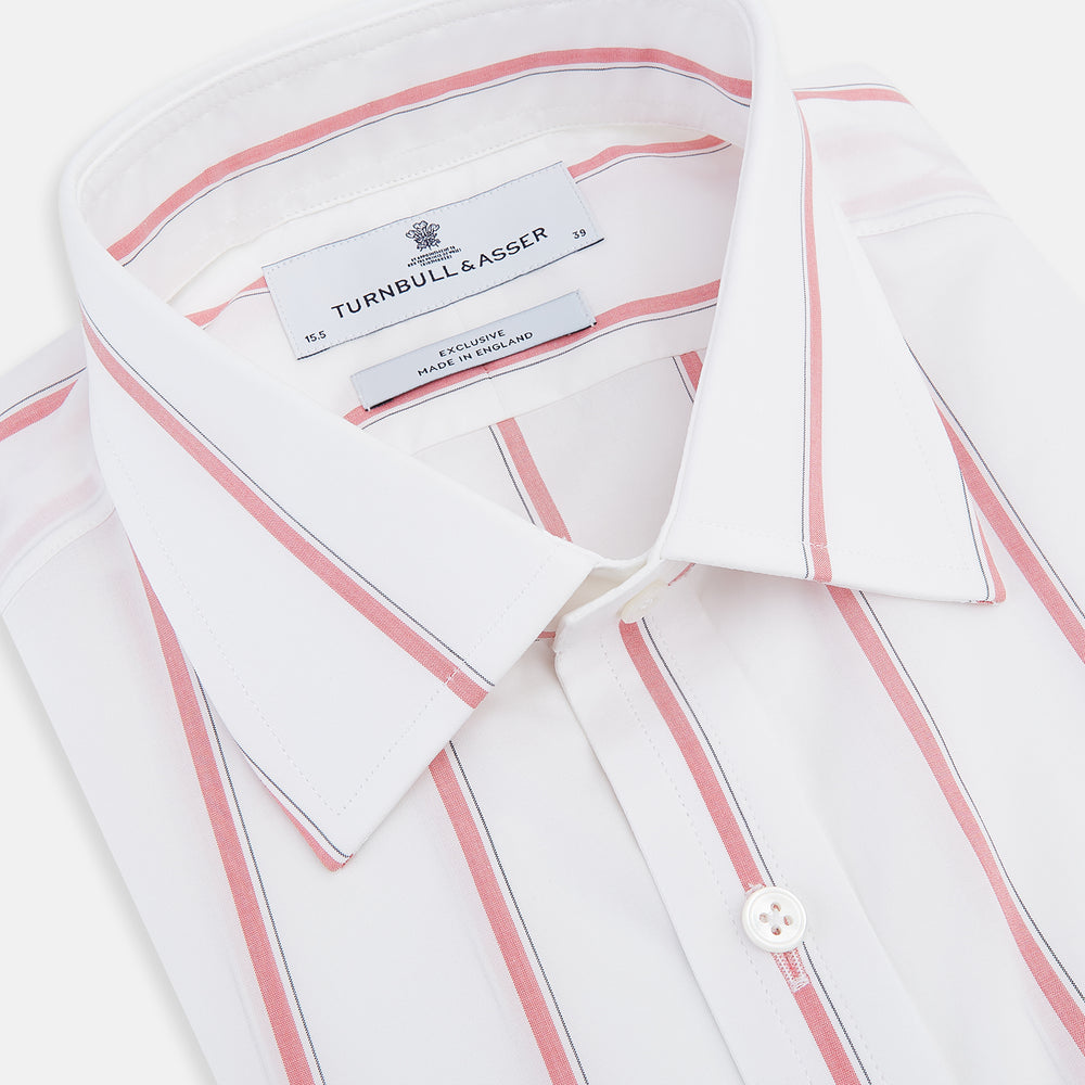 The Turnbull & Asser Coral Track Stripe Mayfair Shirt features a white Italian cotton fabric with vertical red stripes and a pointed T&A collar, shown against a plain light background.