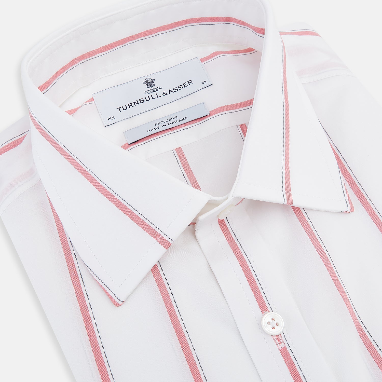 View 2 of product The Turnbull & Asser Coral Track Stripe Mayfair Shirt features a white Italian cotton fabric with vertical red stripes and a pointed T&A collar, shown against a plain light background.