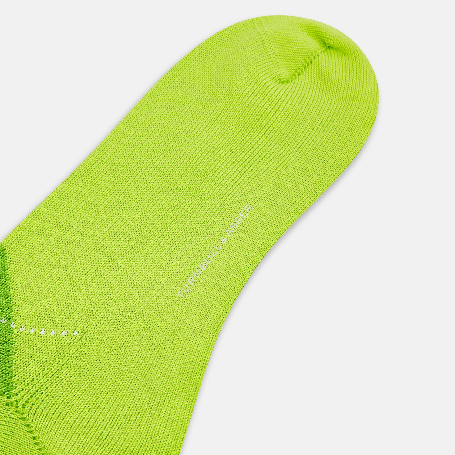 View 3 of product The Lime Check Mid-Length Sock by Turnbull & Asser features a green and yellow argyle pattern with a ribbed cuff, crafted from comfortable cotton material, and is shown on a plain light background.