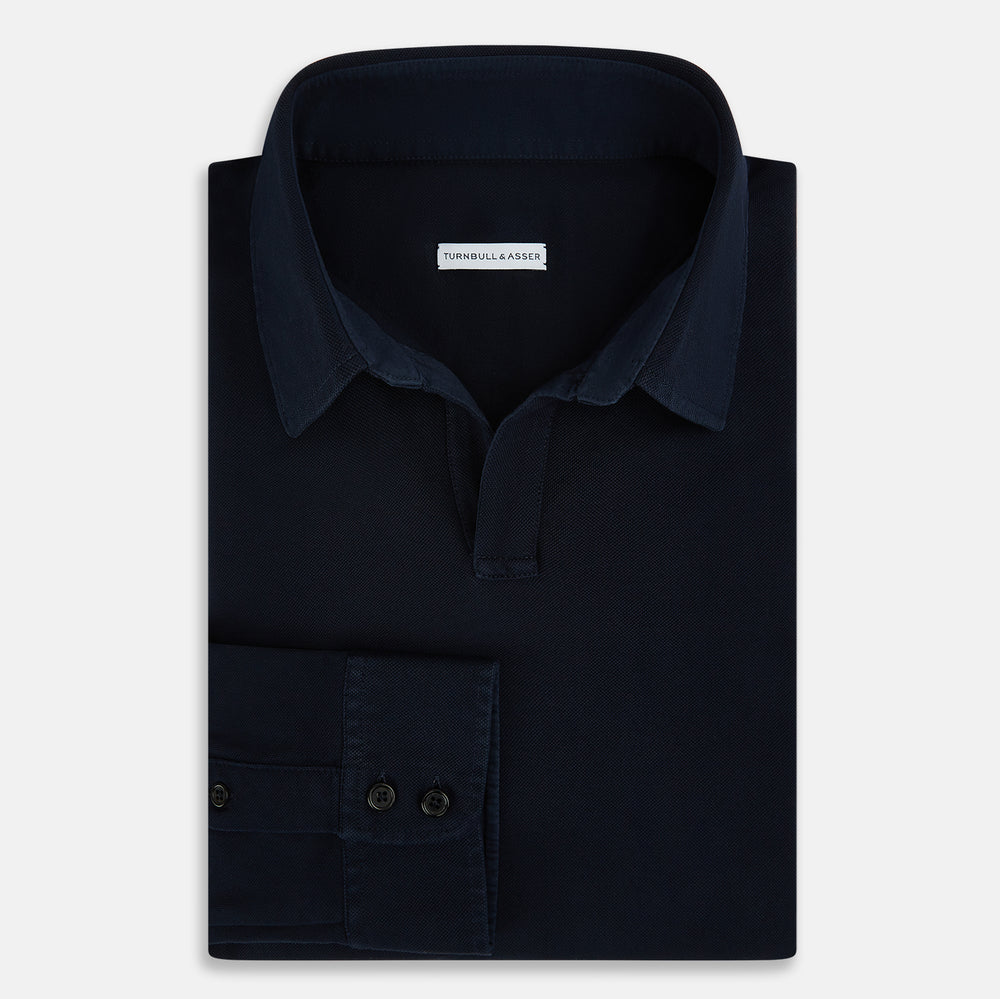 A Navy Rugby Polo Shirt by Turnbull & Asser, featuring long sleeves and a collar, is displayed flat on a white background. The design is simple and free of visible logos or patterns.