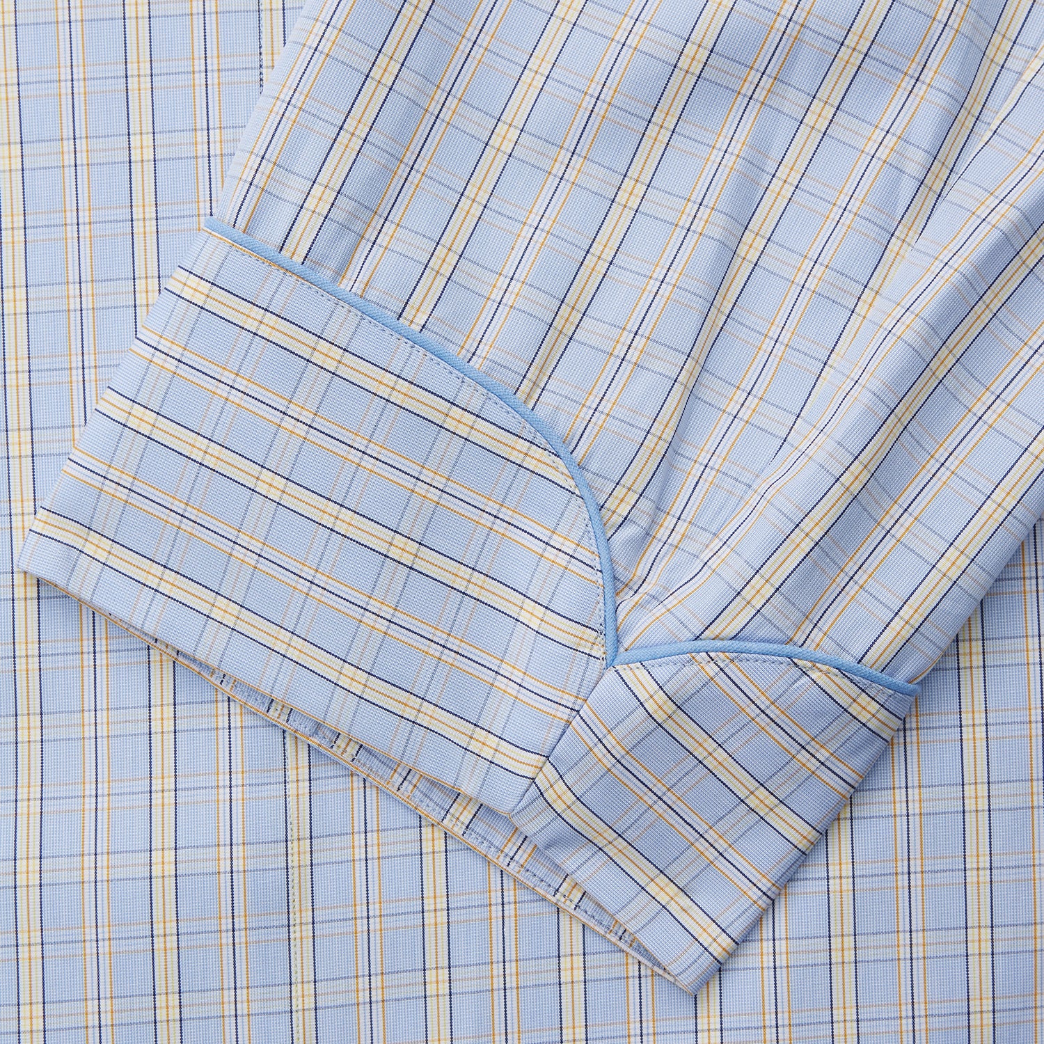 View 3 of product The Turnbull & Asser Blue and Yellow Check Poplin Cotton Dressing Gown features long sleeves, a shawl collar, front pockets, and a matching belt at the waist, shown on a plain white background.