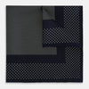 View 1 of product The Turnbull & Asser Navy and Cream Dot Silk Pocket Square features small cream dots, a border design, and displays handmade craftsmanship with one corner folded to show the reverse side.