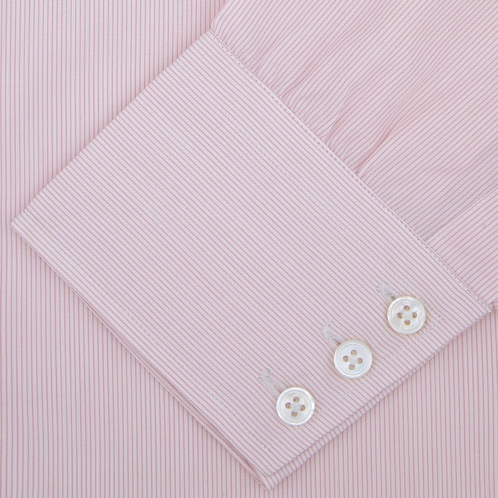 View 2 of product The Turnbull & Asser Pink Hairline Stripe Shirt features a T&A collar and 3-button cuffs, shown neatly folded against a white background—perfect as a smart office shirt.