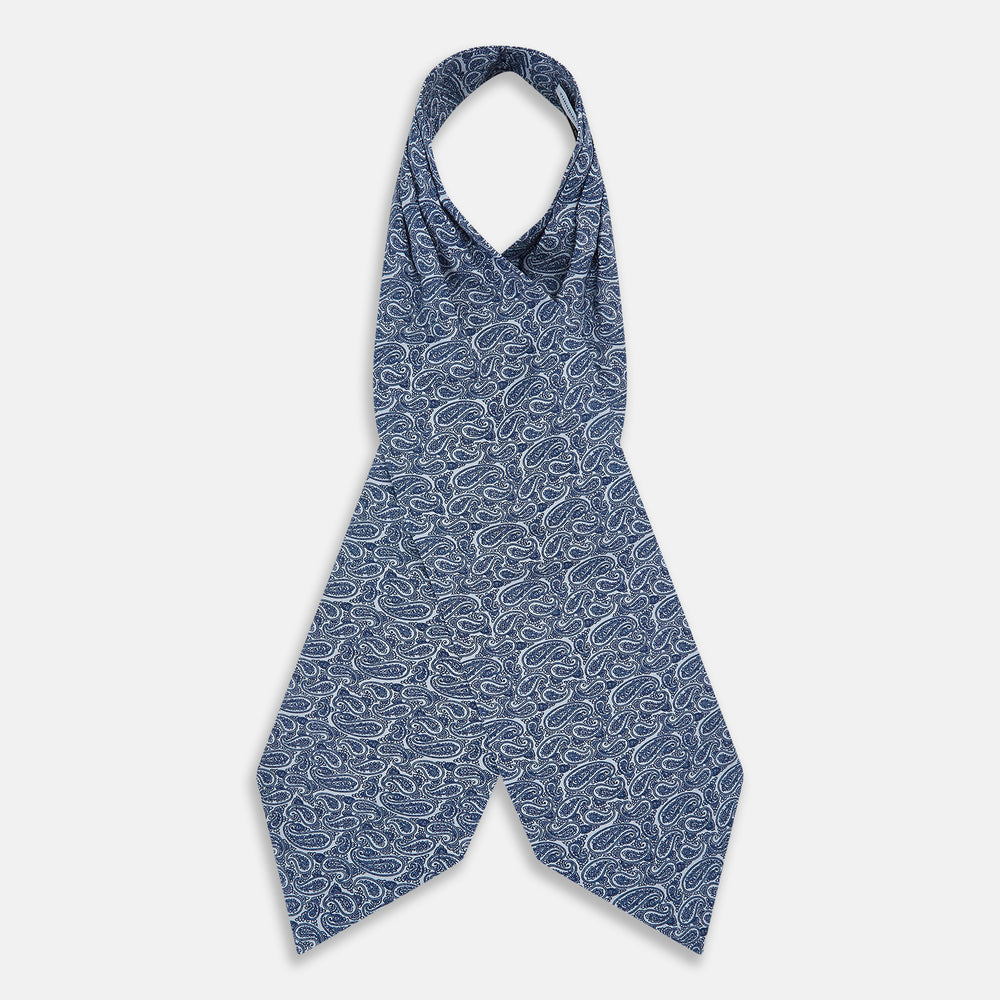 The Pale Blue Paisley Silk Cravat by Turnbull & Asser showcases intricate, swirling blue and white paisley designs on a light background, echoing the elegance of British style accessories.