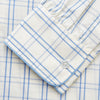 View 3 of product The Turnbull & Asser Cream Multi Cotton Sussex Nightshirt is a knee-length, long-sleeve shirt dress with a blue and beige plaid pattern, collar, front button placket, chest pocket, and rounded hem with side slits.