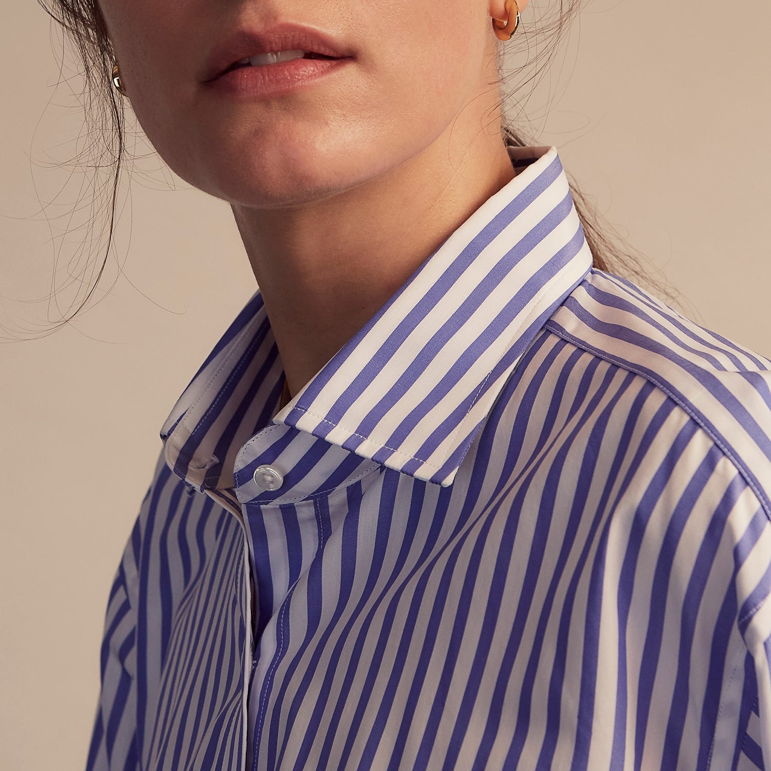 View 7 of product The Turnbull & Asser Pale Blue Candy Stripe Cotton Marlene Shirt is an oversized women's collared shirt with long sleeves, buttoned cuffs, and vertical blue and white stripes, shown laid flat on a white background.
