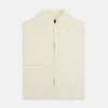 View 4 of product The White Merino High Neck Zipped Cardigan by Turnbull & Asser features a ribbed stand collar, cuffs, and hem. This elegant long-sleeve knitwear piece is shown on a plain white background.