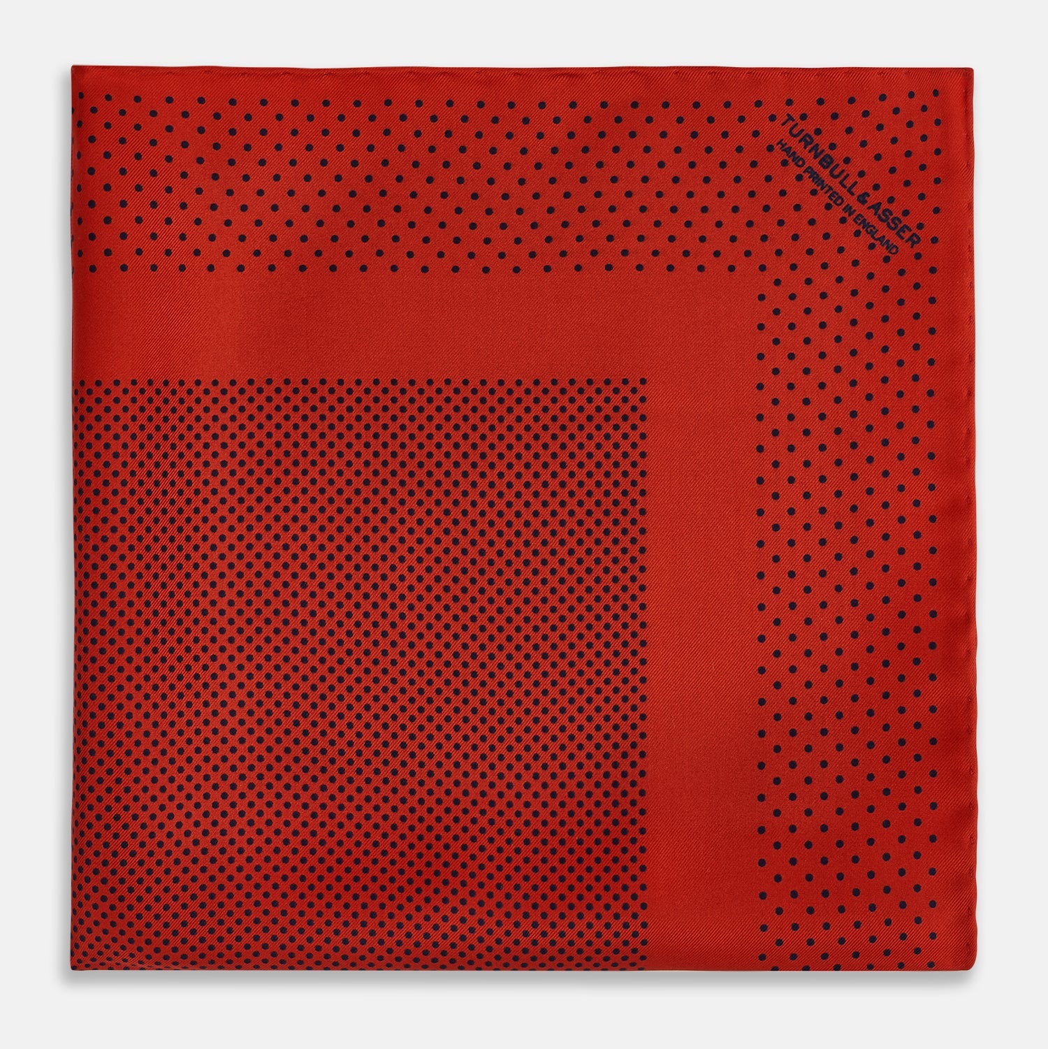 View 3 of product The Turnbull & Asser Red Dot Silk Pocket Square showcases small black dots on red silk, neatly folded to reveal both the front and part of the reverse side.