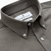 View 2 of product The Turnbull & Asser Dusty Sage Cotton Drill Weekend Fit Nevis Shirt features a button-down collar, long sleeves, two chest pockets, and white buttons, shown folded on a white background.