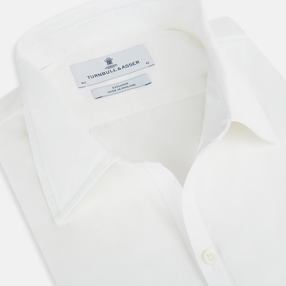 The Turnbull & Asser Plain White Windsor Shirt features a Turnbull open collar, 3-button cuffs, and relaxed fit—exemplifying British craftsmanship. Displayed on a white background.