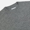 View 2 of product The Turnbull & Asser Grey Melange Cashmere Round Neck Jumper for men features a classic crewneck design with ribbed cuffs, hem, and neckline, displayed against a white background.
