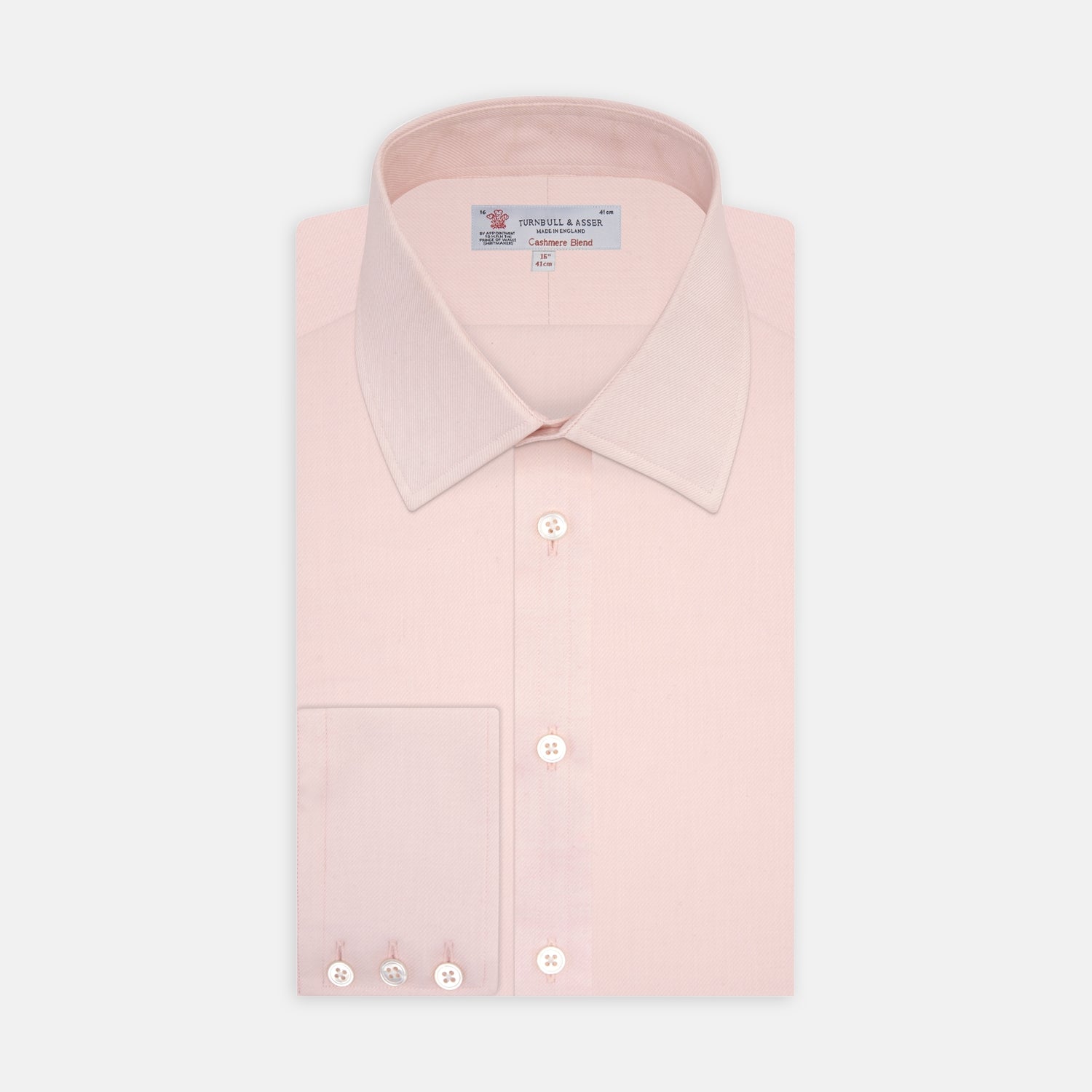 View 1 of product The Turnbull & Asser Pink Cashmere Blend Shirt features a T&A collar and 3-button cuffs, neatly folded with white buttons, displayed on a plain white background.
