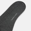View 3 of product A single Grey Organic Cotton Mid-Length Sock by Turnbull & Asser is shown upright on a white background, featuring a ribbed texture and reinforced cuff.