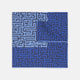 The Blue Maze Silk Pocket Square by Turnbull & Asser features a geometric maze-inspired pattern and central logo, with a folded corner for an artful touch.