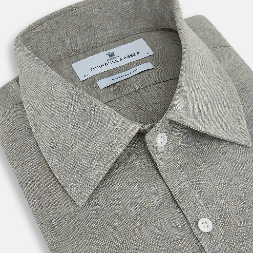 The Flint Grey Linen Westminster Shirt by Turnbull & Asser features long sleeves, a pointed Westminster collar, white buttons, and fine British craftsmanship, shown on a plain white background.