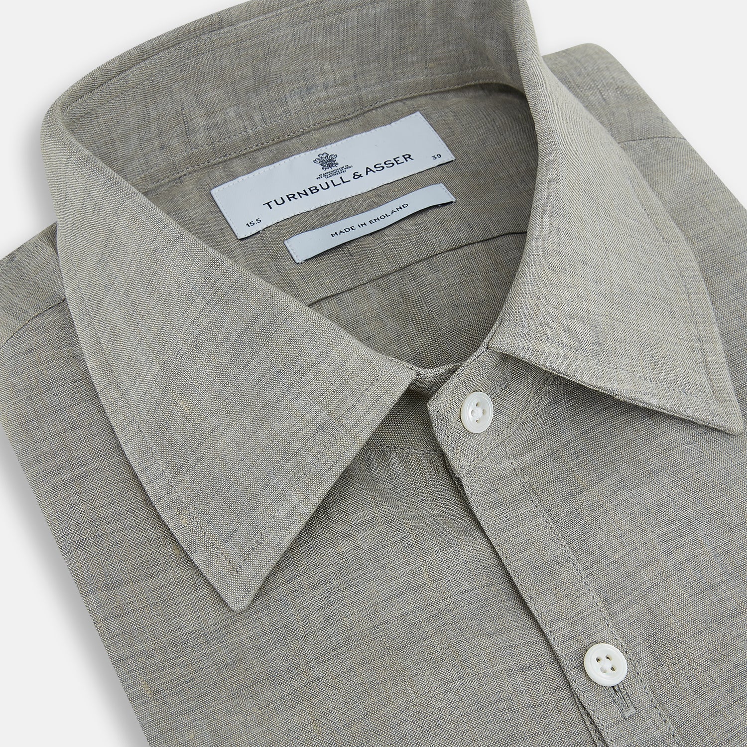 View 2 of product The Flint Grey Linen Westminster Shirt by Turnbull & Asser features long sleeves, a pointed Westminster collar, white buttons, and fine British craftsmanship, shown on a plain white background.