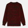 View 3 of product The Turnbull & Asser Russet Red Melange Wool Hafod Cricket Jumper features maroon and black speckles, a V-neck, long sleeves, and ribbed cuffs and hem, displayed flat on a white background.