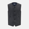 View 1 of product The Turnbull & Asser Ash Quilted Linen Herringbone Waistcoat is sleeveless and dark gray with a V-neck, two zippered side pockets, and a small chest pocket, shown on a plain white background.