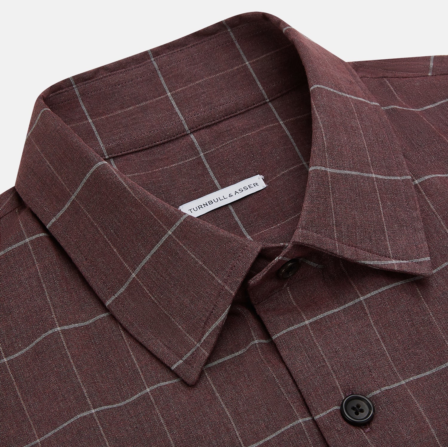 View 2 of product The Turnbull & Asser Burgundy Check Hampstead Overshirt, featuring a button-up front, collar, white windowpane pattern, and two front pockets, is laid flat on a white background—perfect for elegant formal wear.