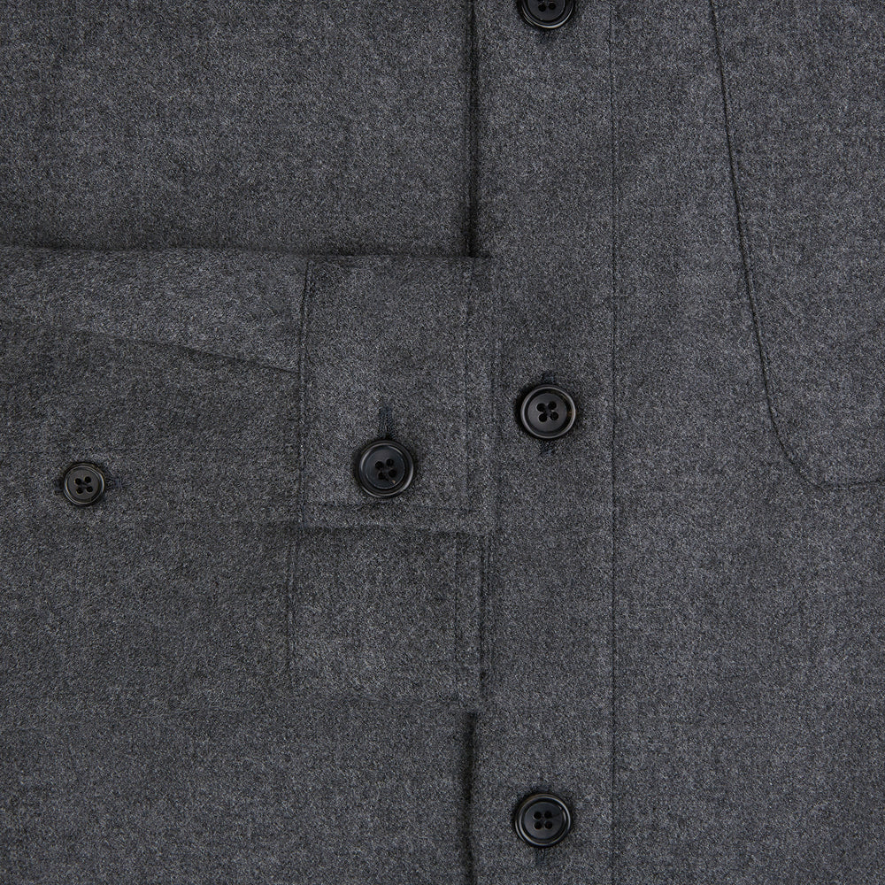 The Grey Highbury Overshirt by Turnbull & Asser is a long-sleeve, button-up charcoal gray overshirt with a single chest pocket, inspired by classic formal jackets and shown laid flat on a white background.