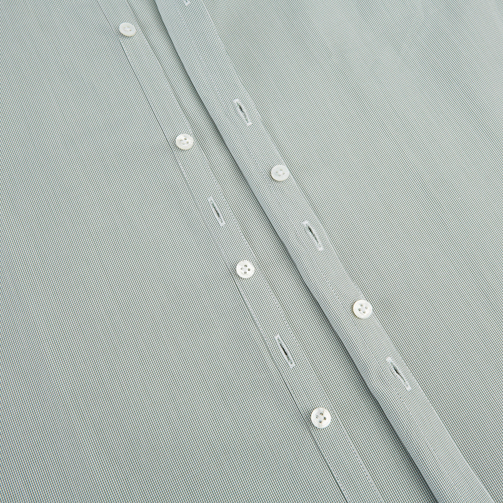 A dark green micro graph check Westminster shirt by Turnbull & Asser, featuring fine British craftsmanship, a Turnbull collar, and white buttons, is laid flat on a white background.