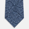 View 3 of product The Turnbull & Asser Dark Navy Paisley Silk Tie, featuring a detailed white paisley pattern, is neatly rolled and displayed against a plain white background.