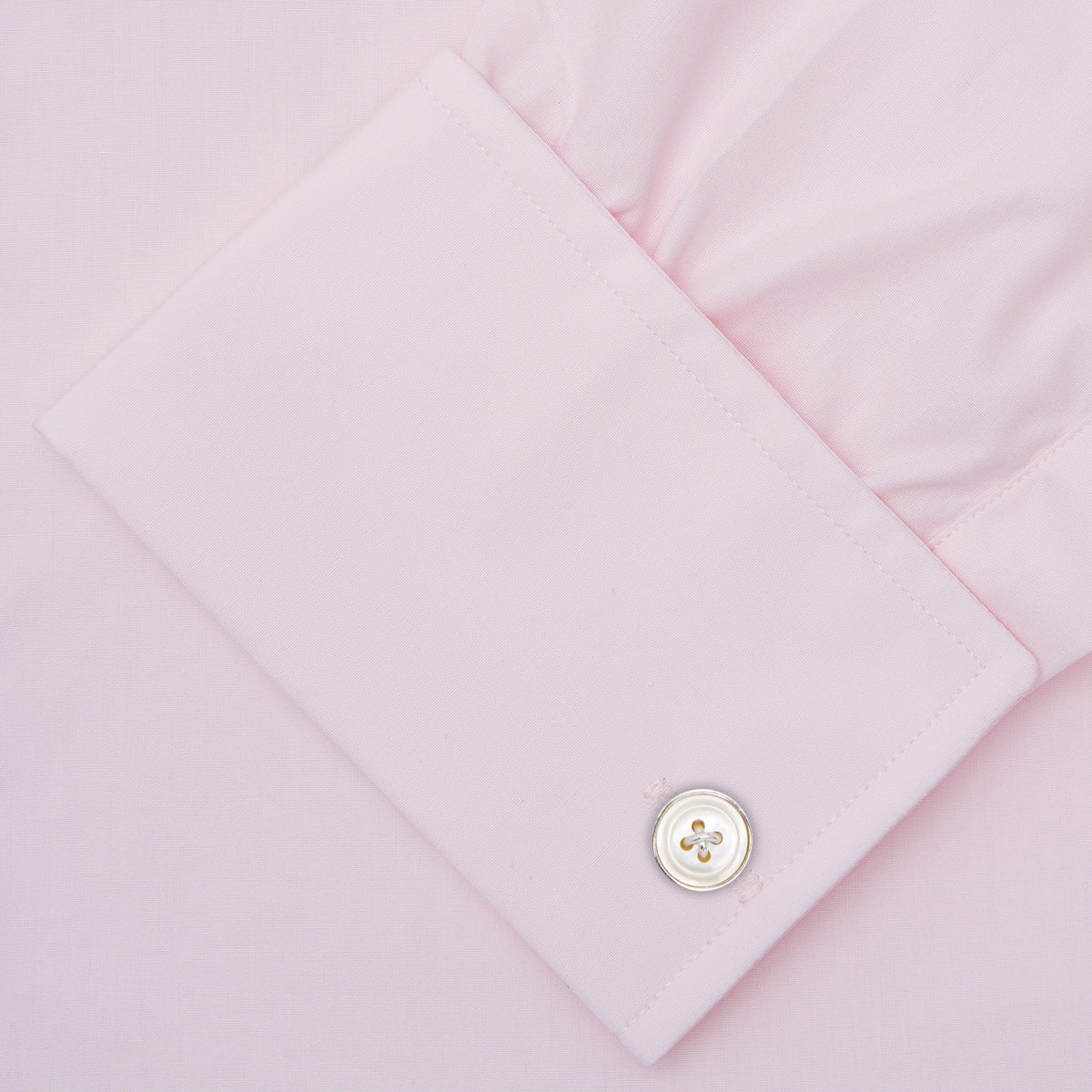 View 3 of product A Turnbull & Asser Pink Cotton Shirt with a T&A collar and double cuffs is displayed against a white background. The men's shirt features long sleeves, white buttons, and the label is visible inside the collar.