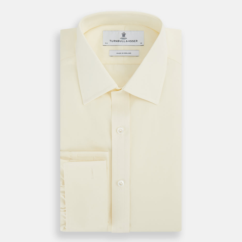 The Turnbull & Asser Cream Cotton Shirt features a T&A collar and double cuffs, elevating men's style. Displayed flat against a white background, this long-sleeve shirt is crafted in classic cream cotton.