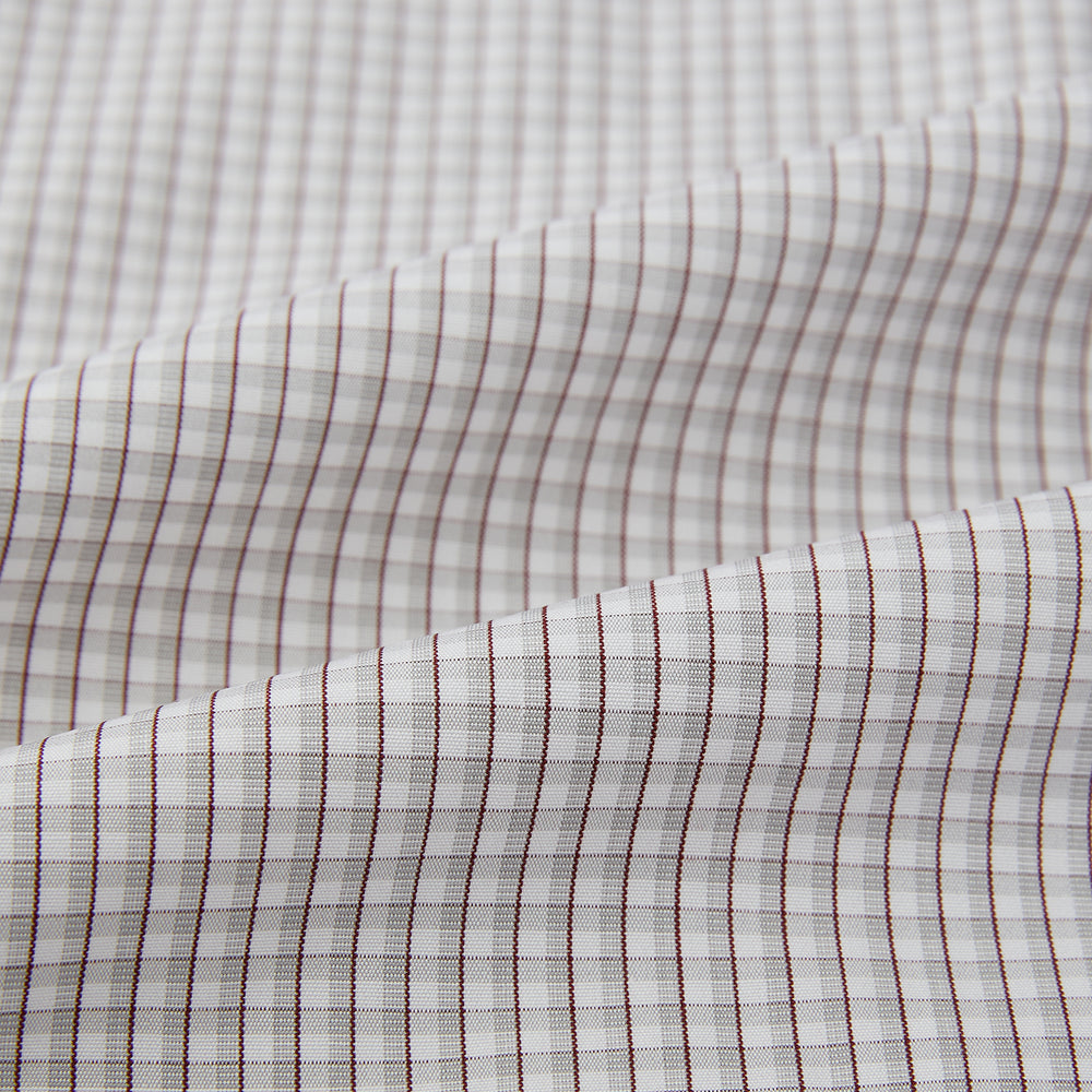 The Turnbull & Asser Grey Micro Shadow Check Mayfair Shirt is crafted from premium Italian cotton with long sleeves, a collar, and buttoned cuffs, shown folded flat against a white background.