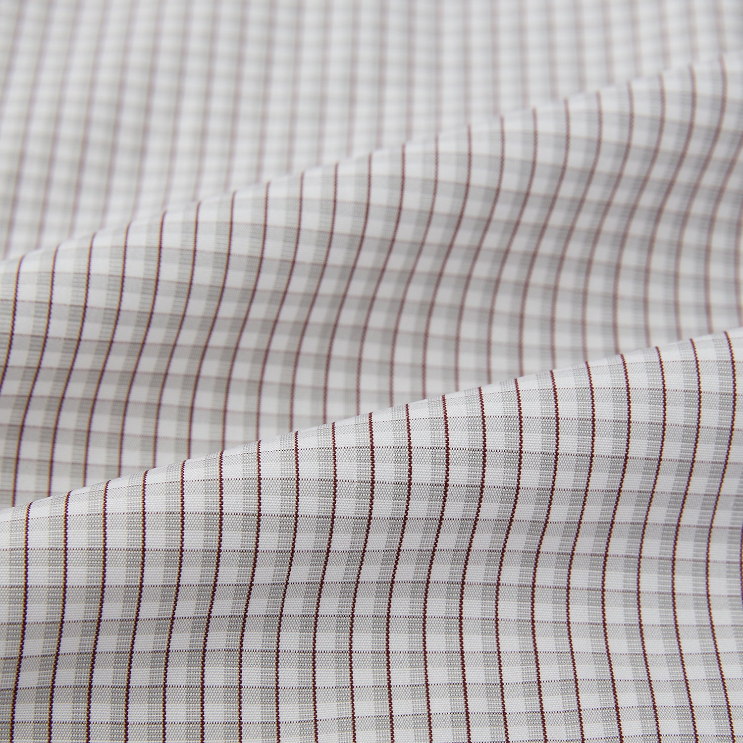 View 6 of product The Turnbull & Asser Grey Micro Shadow Check Mayfair Shirt is crafted from premium Italian cotton with long sleeves, a collar, and buttoned cuffs, shown folded flat against a white background.