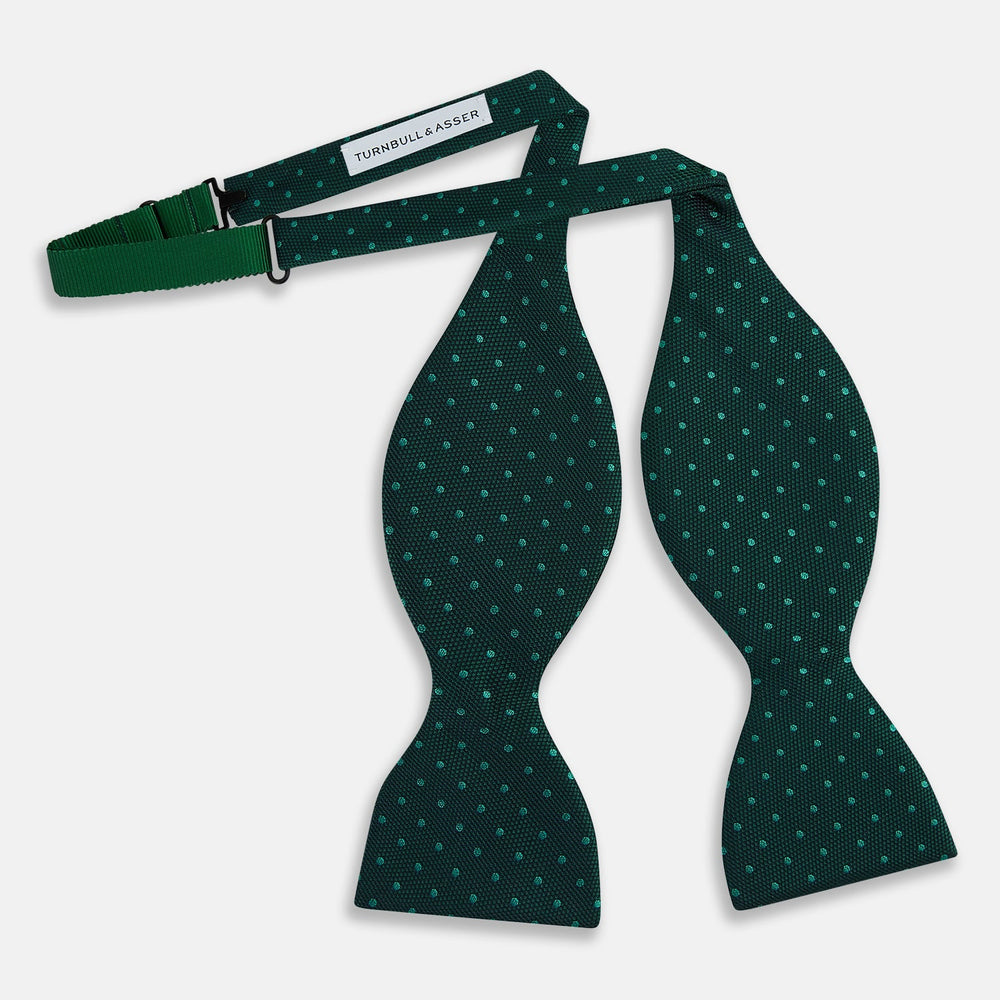 The Turnbull & Asser Dark Green and Navy Micro Dot Silk Bow Tie, featuring a refined dotted pattern, is showcased on a plain white background—an elegant accessory perfect for any occasion.
