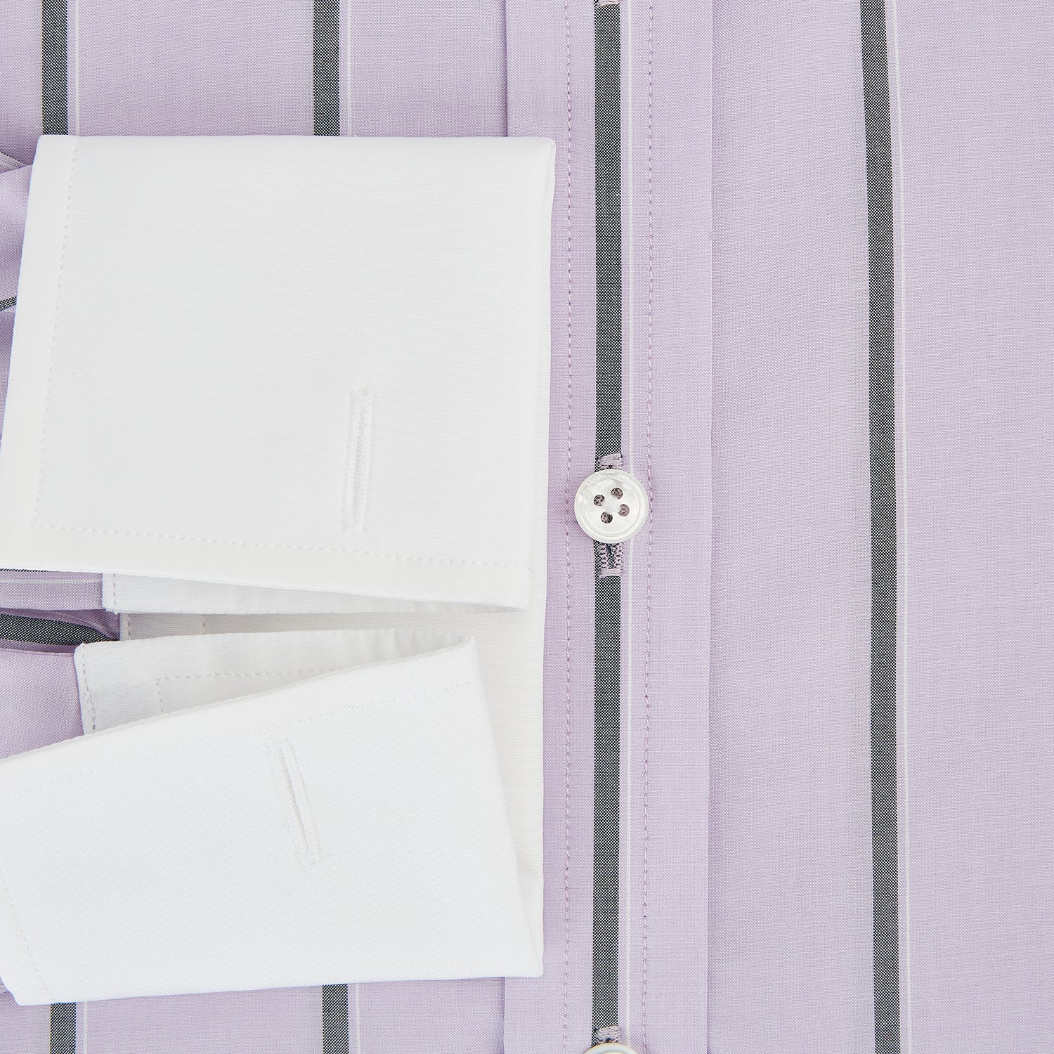 View 4 of product The Turnbull & Asser Lilac Track Stripe Shirt with Contrast T&A Collar and Cuffs features vertical black stripes, a white pointed collar, and white cuffs, shown flat against a white background.