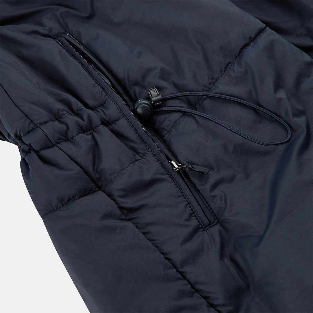 The Turnbull & Asser Charcoal Melange John Arthur Trench Coat, featuring a collar, single-breasted closure, and three zippered pockets—one chest and two at the hips—is shown against a plain white background.