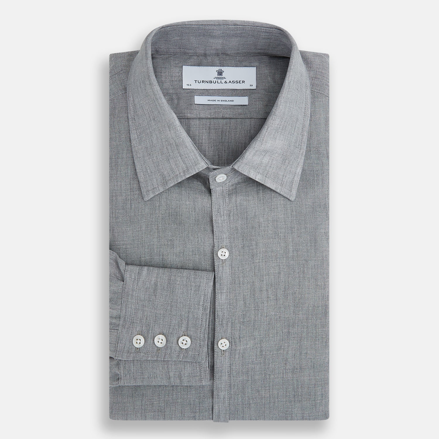 View 5 of product The Grey Linen Westminster Shirt by Turnbull & Asser is a long-sleeve, light gray button-up with a formal collar and white buttons, highlighting British craftsmanship and laid flat on a white background.