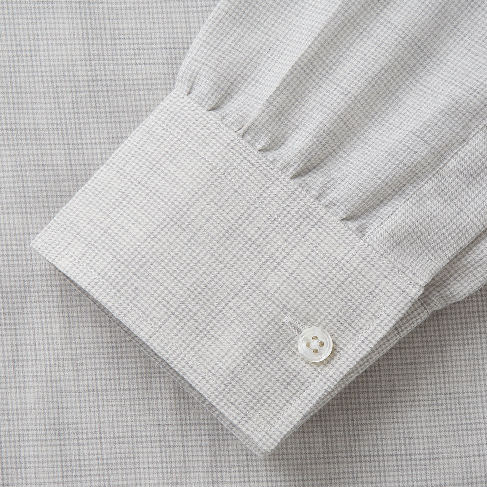 A Grey Fine Check Cotton Blend Weekend Fit Suffolk Shirt by Turnbull & Asser with long sleeves, a collar, and single chest pocket is laid flat on a white background.