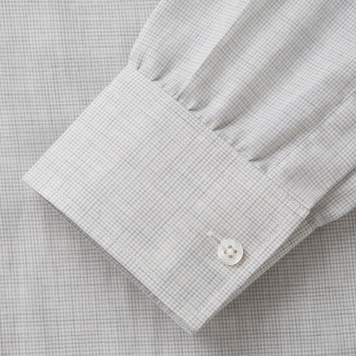 View 4 of product A Grey Fine Check Cotton Blend Weekend Fit Suffolk Shirt by Turnbull & Asser with long sleeves, a collar, and single chest pocket is laid flat on a white background.