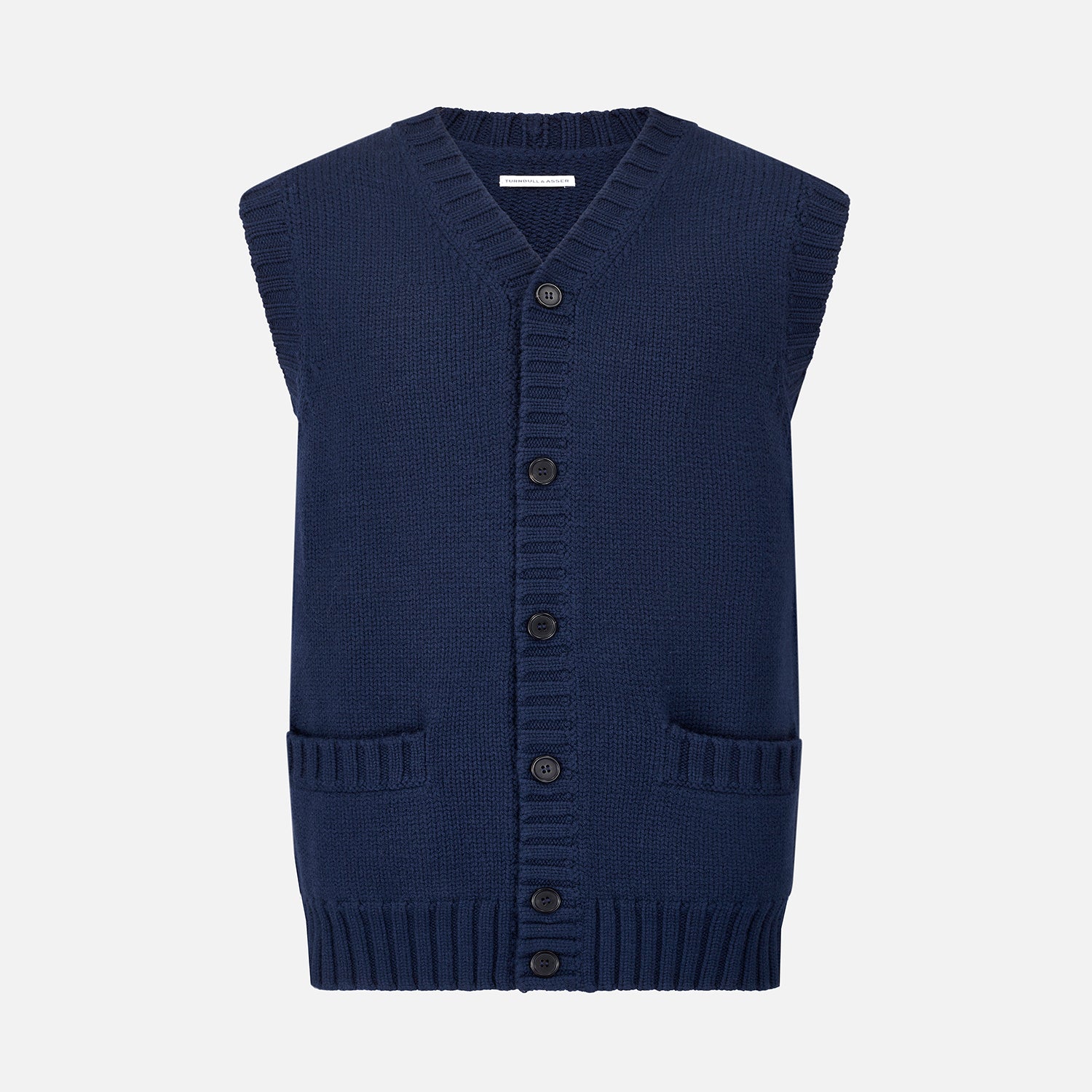View 1 of product The NAVY MERINO V-NECK SLEEVELESS CARDIGAN by Turnbull & Asser features a button-down front, ribbed edges, and two front pockets—an elegant layering piece for stylish menswear.