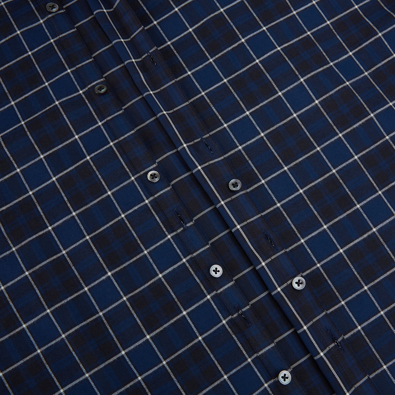 View 7 of product The Turnbull & Asser Navy and White Check Windsor Shirt features a long-sleeve design with a navy base and white check pattern, showcasing British craftsmanship and displayed on a white background.