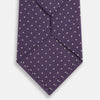 View 3 of product The Turnbull & Asser Lavender and Purple Micro Dot Silk Tie is displayed rolled-up against a plain white background.