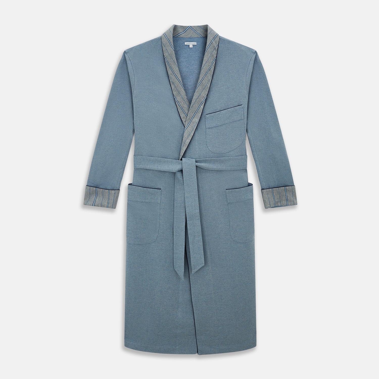 View 1 of product The Turnbull & Asser Blue Stripe Collar Cotton Twill Gown features a light blue hue, striped collar and cuffs, long sleeves, patch pockets, and a matching belt for elevated home comfort. Shown on a white background.