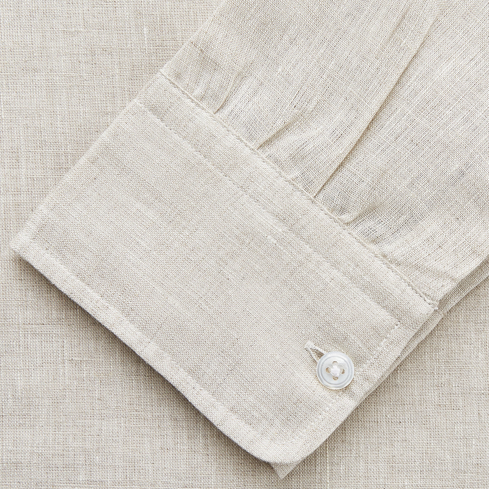 The Turnbull & Asser Light Oatmeal Linen Weekend Fit Unwin Shirt features long sleeves, a band collar, and two chest pockets—an ideal choice for effortless summer style.