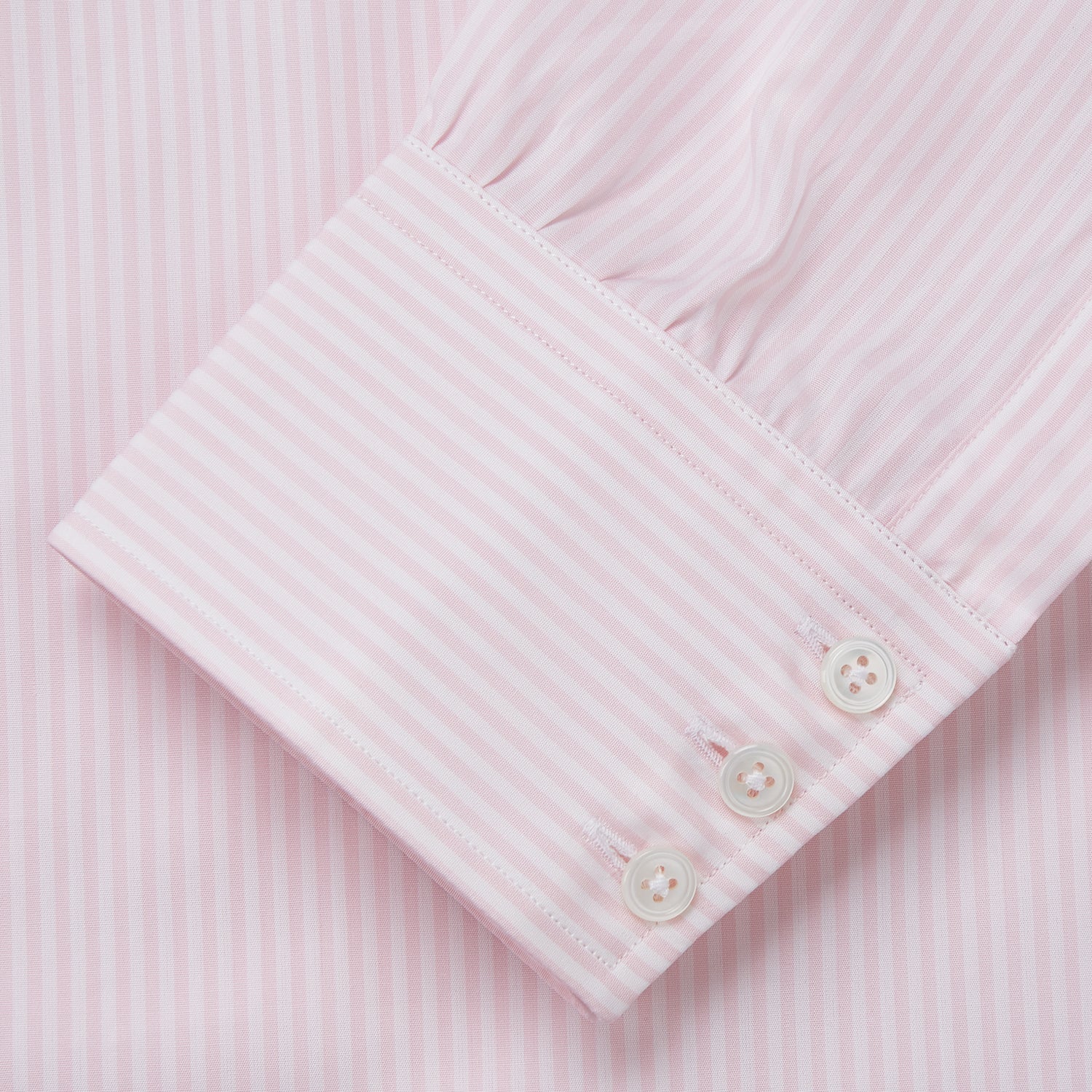 View 3 of product The Turnbull & Asser White and Pink Wide Stripe Mayfair Shirt features long sleeves, a collar, and bold vertical stripes, shown laid flat on a white background.