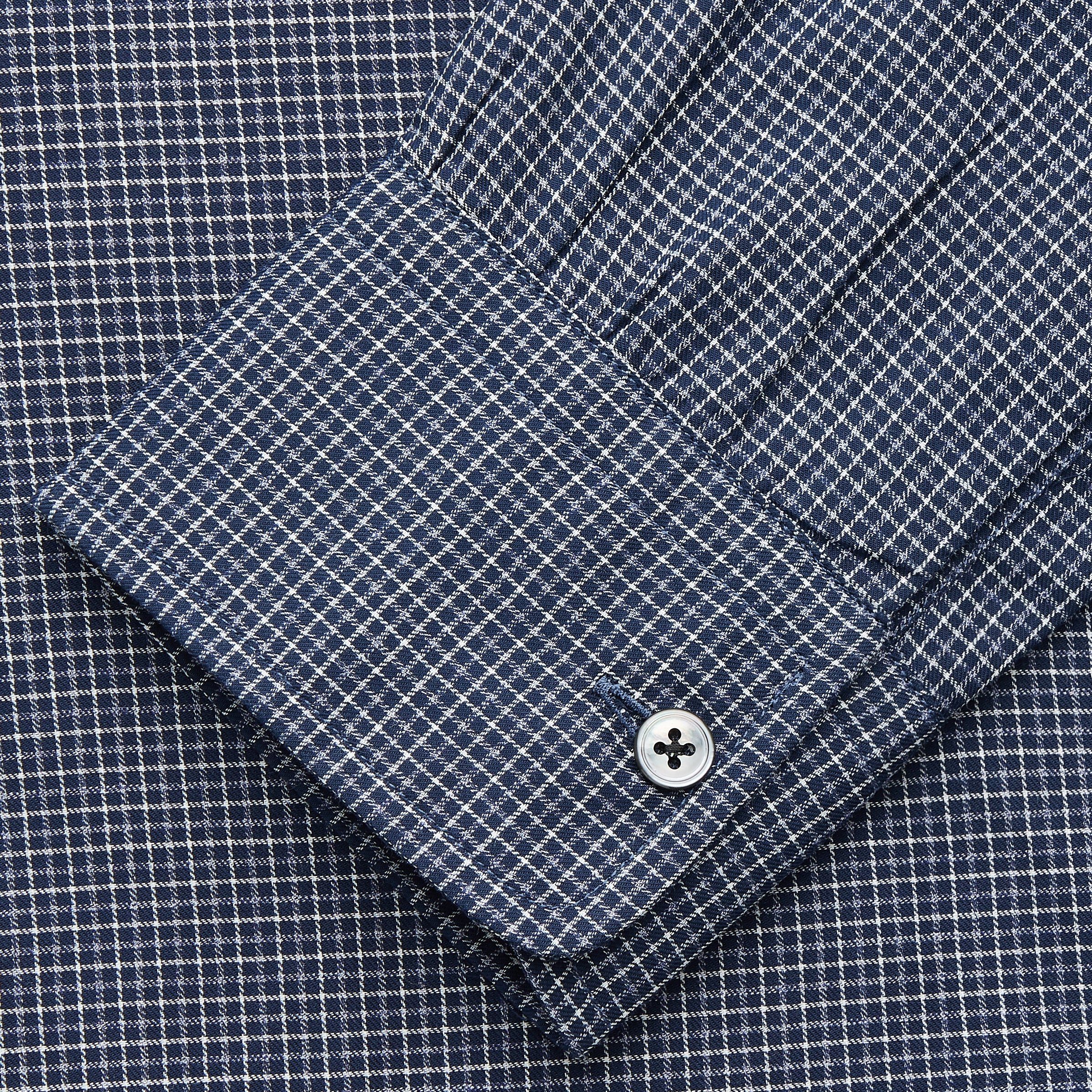View 3 of product The Turnbull & Asser Navy Check Weekend Fit Flannel Shirt features a stand collar, button front, two chest pockets with flaps, and 1-button cuffs, crafted from soft Italian cotton and shown laid flat on a white background.