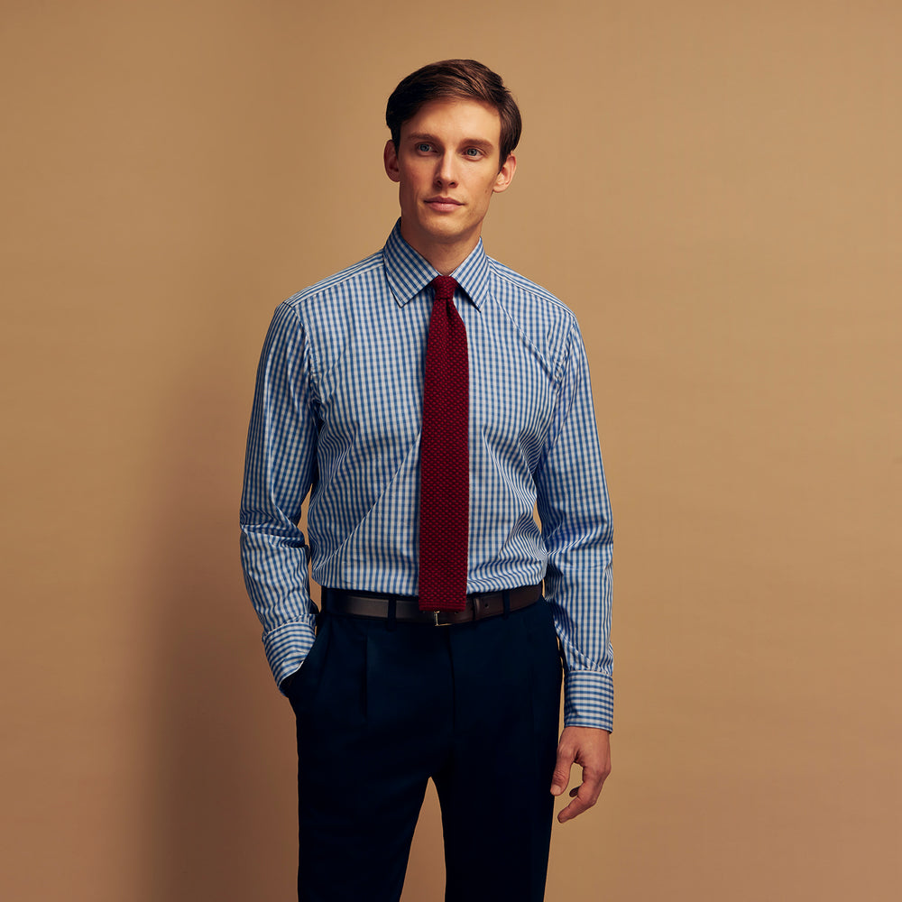 The Turnbull & Asser Navy Multi Check Cotton Regular Fit Mayfair Shirt features long sleeves, button-down front, collar, and buttoned cuffs in a navy and white check pattern, shown against a plain white background.