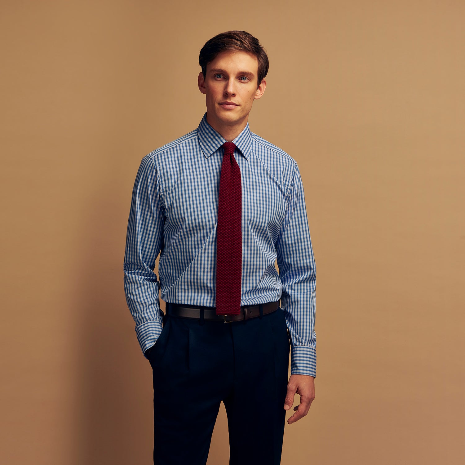 View 6 of product The Turnbull & Asser Navy Multi Check Cotton Regular Fit Mayfair Shirt features long sleeves, button-down front, collar, and buttoned cuffs in a navy and white check pattern, shown against a plain white background.