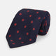 The EMBLEM SPOT NAVY TULIP TIE by Turnbull & Asser features a navy base with red circle motifs, neatly rolled on a white background—an essential accessory for refined style.