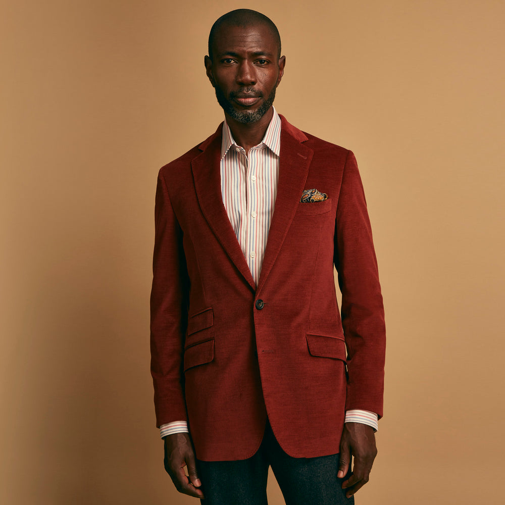 The Rust Cord Barrington Blazer by Turnbull & Asser is tailored in Italy with notch lapels, two front buttons, three pockets, and four-button cuffs, shown flat on a white background.