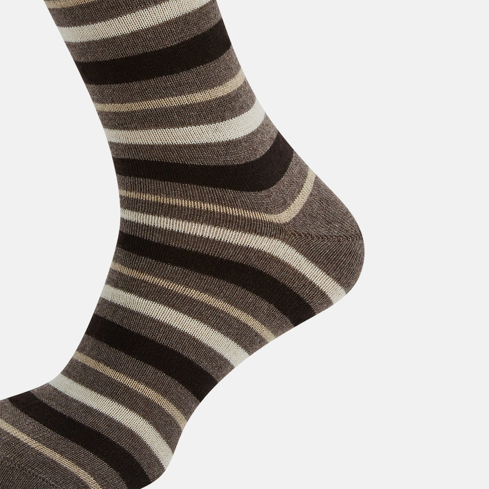 The Coffee Striped Merino Wool Long Socks by Turnbull & Asser feature knee-high length with horizontal brown, beige, and cream stripes, shown against a plain white background.