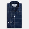 View 5 of product The Indigo and White Thin Plaid Check Windsor Shirt by Turnbull & Asser, a long-sleeve button-up with white buttons, is shown laid flat on a white background.